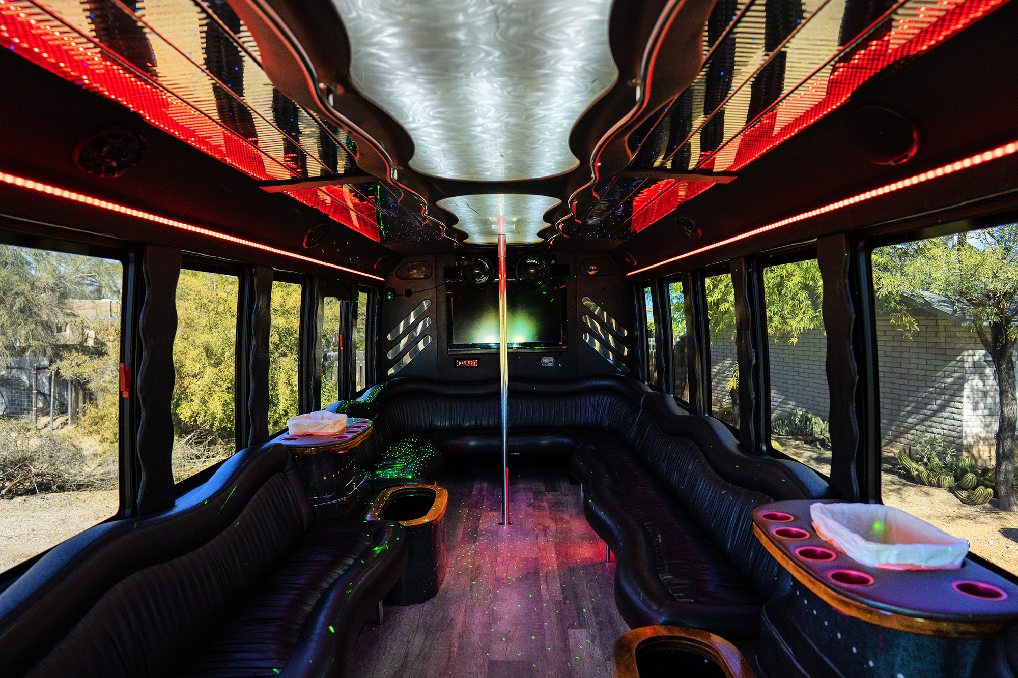 Inside one of our large party buses with red neon lights