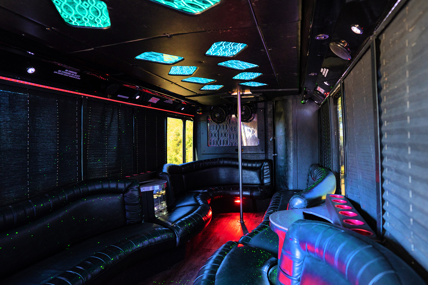 Inside the small party bus with neons and pole