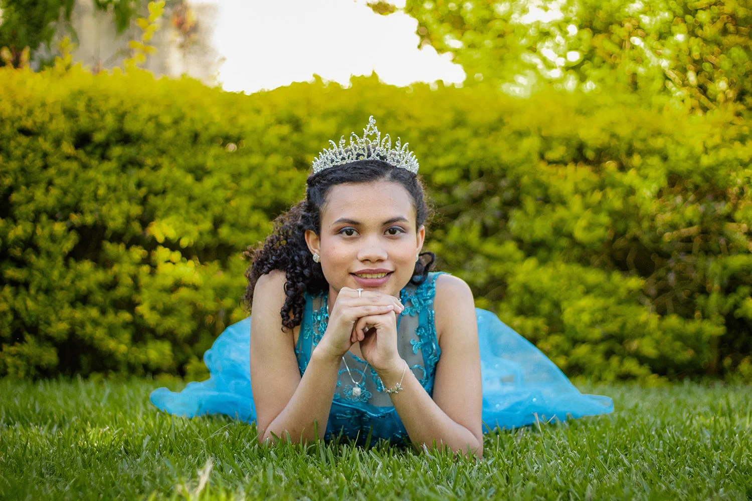 quinceanera Girl in blue dress and tiara on the day of her quinceanera